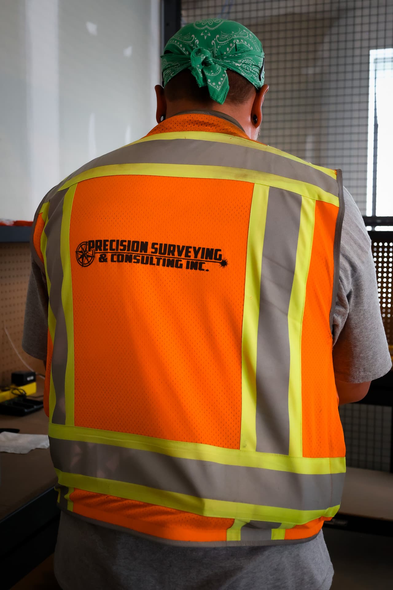 A team member wearing a precision brandedsafety vest